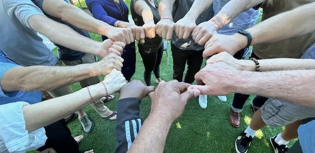 Participants joining hands during a group exercise