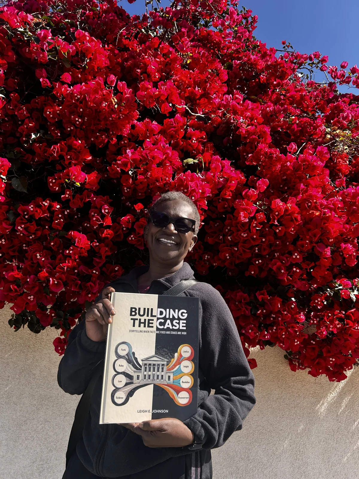 Leigh E. Johnson holding a copy of Building the Case